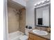 Bathroom with tub and tiled shower, granite counter and decorative mirror at 21032 Voyager Blvd # 8, Land O Lakes, FL 34638