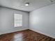 Clean, freshly painted bedroom with window and wood-look flooring at 21032 Voyager Blvd # 8, Land O Lakes, FL 34638