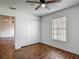 Bedroom features wood floors, window with blinds and double-door closet at 21032 Voyager Blvd # 8, Land O Lakes, FL 34638