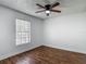 Bedroom features hardwood floors, a ceiling fan, and a bright window at 21032 Voyager Blvd # 8, Land O Lakes, FL 34638