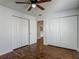 Bright bedroom with ceiling fan, wood floors, and double door closet at 21032 Voyager Blvd # 8, Land O Lakes, FL 34638