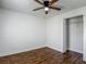 A bedroom with a ceiling fan, hardwood floors, and open closet at 21032 Voyager Blvd # 8, Land O Lakes, FL 34638