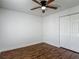Bedroom featuring hardwood floors, a ceiling fan, and a closet at 21032 Voyager Blvd # 8, Land O Lakes, FL 34638