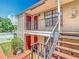 Exterior shot of an apartment balcony and staircase, showcasing outdoor living space and access at 21032 Voyager Blvd # 8, Land O Lakes, FL 34638