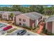 Exterior view of an apartment with red brick accents, well-maintained landscaping, and parking area at 21032 Voyager Blvd # 8, Land O Lakes, FL 34638
