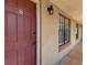 Apartment front door featuring unit number and exterior details; window on right of entry at 21032 Voyager Blvd # 8, Land O Lakes, FL 34638