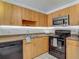 Kitchen featuring stainless steel microwave, range, and wood cabinetry and countertops at 21032 Voyager Blvd # 8, Land O Lakes, FL 34638