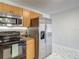 Kitchen with stainless steel refrigerator, range, microwave, and marble flooring at 21032 Voyager Blvd # 8, Land O Lakes, FL 34638