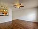 Spacious living room featuring hardwood floors, ceiling fan, and pass-through to kitchen at 21032 Voyager Blvd # 8, Land O Lakes, FL 34638