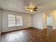 Spacious living room featuring hardwood floors, a large window, and a ceiling fan at 21032 Voyager Blvd # 8, Land O Lakes, FL 34638