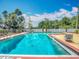 A refreshing swimming pool with lounge chairs for relaxation at 21032 Voyager Blvd # 8, Land O Lakes, FL 34638