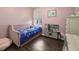 A well-lit bedroom showing a bed, play kitchen, and a window at 2350 126Th E Dr, Parrish, FL 34219