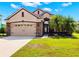 Charming single-Gathering home with a well-manicured lawn, a two car garage, and stone facade accents at 2350 126Th E Dr, Parrish, FL 34219