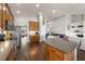Well-equipped kitchen with hardwood floors, granite counters, oak cabinetry, stainless appliances and an island at 2350 126Th E Dr, Parrish, FL 34219