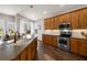 Kitchen with stainless steel appliances, granite countertops, oak cabinets, and hardwood floors at 2350 126Th E Dr, Parrish, FL 34219
