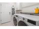 Bright laundry room with washer and dryer, white cabinets, and neutral walls at 2350 126Th E Dr, Parrish, FL 34219