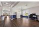 Bright living room with hardwood floors, white trim, and a work space near the window at 2350 126Th E Dr, Parrish, FL 34219