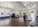 Spacious living room with large windows, hardwood floors, a modern chandelier and stylish decor at 2350 126Th E Dr, Parrish, FL 34219