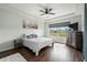Bedroom with a tray ceiling and large window overlooking the backyard at 2350 126Th E Dr, Parrish, FL 34219