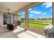 Screened patio with chairs and a view of the backyard and pond at 2350 126Th E Dr, Parrish, FL 34219