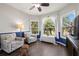 Cozy sitting area with hardwood floors, comfortable seating, large windows and decorative curtains at 2350 126Th E Dr, Parrish, FL 34219