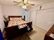 Bedroom featuring a ceiling fan, closet, dresser, and warm lighting at 2434 Australia E Way # 38, Clearwater, FL 33763