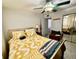 Bedroom featuring a ceiling fan, sliding mirrored door, and warm lighting at 2434 Australia E Way # 38, Clearwater, FL 33763