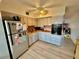 Bright kitchen featuring ample cabinet space, light wood flooring, and stainless steel refrigerator at 2434 Australia E Way # 38, Clearwater, FL 33763