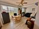 Living room featuring a dining table, ceiling fan, and large window for ample natural light at 2434 Australia E Way # 38, Clearwater, FL 33763