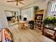 Living room with light wood flooring, bookcase, a round table, and large window providing lots of natural light at 2434 Australia E Way # 38, Clearwater, FL 33763