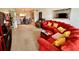Spacious living room with a red sofa, carpet, and open access to the dining room at 2434 Australia E Way # 38, Clearwater, FL 33763