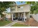 Home exterior features a covered patio with comfortable seating and backyard playground at 2616 11Th N St, St Petersburg, FL 33704
