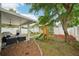 The fenced backyard features a covered patio, lounge seating, playground and lush landscaping at 2616 11Th N St, St Petersburg, FL 33704