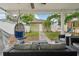 Backyard features a covered patio, lounge seating, hanging chair and a playground set at 2616 11Th N St, St Petersburg, FL 33704