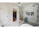 Bright bathroom features a large glass shower, storage niches and easy access to the walk-in closet and laundry room at 2616 11Th N St, St Petersburg, FL 33704