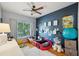 A bedroom with a car-shaped bed, complemented by a soft rug, and natural light from the window at 2616 11Th N St, St Petersburg, FL 33704