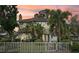 Charming two-story home featuring a white picket fence and mature landscaping at 2616 11Th N St, St Petersburg, FL 33704