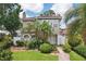 Charming home with beautiful landscaping, tropical plants, and a lovely walkway at 2616 11Th N St, St Petersburg, FL 33704