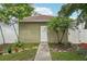 View of detached garage next to landscaping and plants in the backyard of the home at 2616 11Th N St, St Petersburg, FL 33704