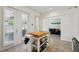 Bright kitchen featuring a movable island with butcher block top and white cabinets and access to a living area at 2616 11Th N St, St Petersburg, FL 33704