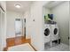 Hallway featuring laundry closet with front loading washer and dryer and access to bathroom at 2616 11Th N St, St Petersburg, FL 33704