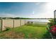 A lush backyard with fencing offering serene lake views at 3091 King Fern Dr, Wimauma, FL 33598