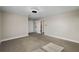 This bedroom features plush carpeting, neutral paint, and an ensuite bathroom at 3091 King Fern Dr, Wimauma, FL 33598