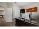 This home office features natural light, plush carpet, and a spacious work area at 3091 King Fern Dr, Wimauma, FL 33598