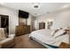 Comfortable main bedroom featuring an en-suite bathroom, closet, dresser, and TV at 3091 King Fern Dr, Wimauma, FL 33598