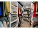 Well-organized walk-in closet featuring shelves, hanging rods, baskets, and ample storage space at 3091 King Fern Dr, Wimauma, FL 33598
