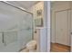 Bathroom with glass shower doors, neutral tones, and modern fixtures at 311 Knottwood Ct, Sun City Center, FL 33573