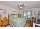 Comfortable bedroom featuring a ceiling fan, wood floors, and a bright window at 311 Knottwood Ct, Sun City Center, FL 33573