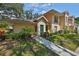 Inviting single-story home with manicured lawn and a walkway leading to the front door at 311 Knottwood Ct, Sun City Center, FL 33573