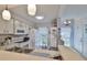Bright kitchen features white appliances, ample cabinet space, and a breakfast bar at 311 Knottwood Ct, Sun City Center, FL 33573